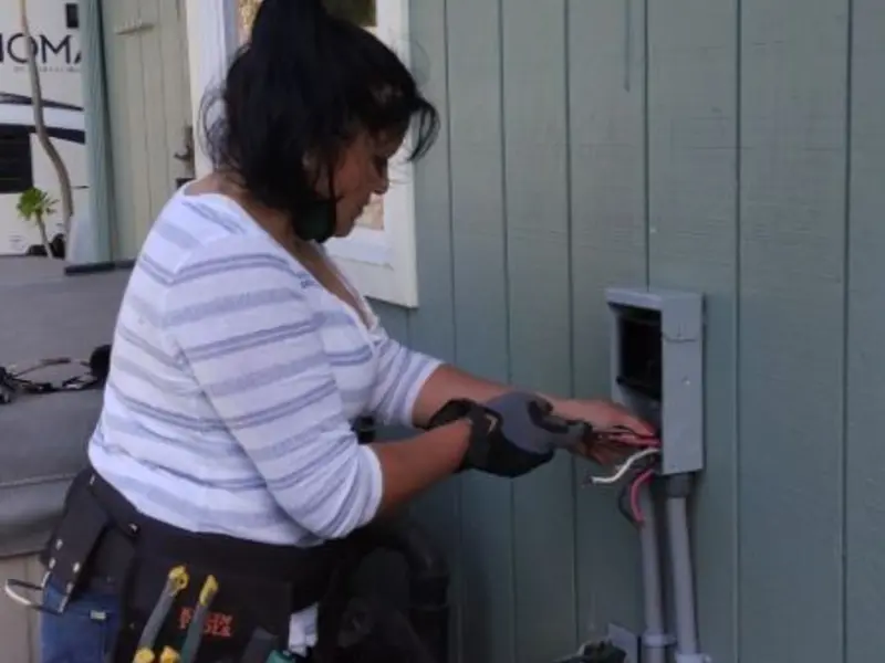 Licensed electrician wiring an exterior subpanel in Sheffield